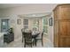 Cozy dining nook with a round table, seating for four, and bay windows providing ample natural light at 1355 Red Oak Ln, Port Charlotte, FL 33948