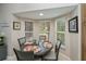 Bright dining area featuring a round table, bay windows and neutral toned walls at 1355 Red Oak Ln, Port Charlotte, FL 33948