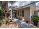 Charming front entrance with gravel pathway leading to a screened in porch and decorative front door at 1355 Red Oak Ln, Port Charlotte, FL 33948