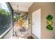 Charming front porch featuring a decorative statue and views of lush greenery outside at 1355 Red Oak Ln, Port Charlotte, FL 33948