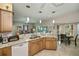 Open concept kitchen featuring granite countertops, stainless steel appliances, and natural wood cabinets at 1355 Red Oak Ln, Port Charlotte, FL 33948