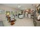 Bright open-concept living room with tile flooring, ceiling fan, and sliding glass doors to the lanai at 1355 Red Oak Ln, Port Charlotte, FL 33948
