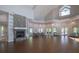 Expansive meeting room with stone fireplace, high ceilings, and ample natural light, perfect for community gatherings and events at 1355 Red Oak Ln, Port Charlotte, FL 33948