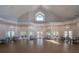 Bright meeting room featuring vaulted ceilings, decorative lighting, and multiple seating areas, ideal for various community activities at 1355 Red Oak Ln, Port Charlotte, FL 33948