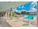Charming poolside veranda with comfortable rocking chairs, offering a relaxing space overlooking the sparkling community pool at 1355 Red Oak Ln, Port Charlotte, FL 33948