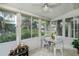 Inviting sunroom with large windows offering views of the surrounding greenery at 1355 Red Oak Ln, Port Charlotte, FL 33948