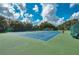 Outdoor tennis courts with green and blue surface provide a beautiful recreational space in a well-maintained community at 1355 Red Oak Ln, Port Charlotte, FL 33948