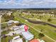 Beautiful aerial view of a community with a golf course and waterways winding through a residential area on a sunny day at 1356 Rio De Janeiro Ave # 107, Punta Gorda, FL 33983