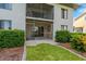 Backyard with a screened-in patio, grass, and landscaping at 1356 Rio De Janeiro Ave # 107, Punta Gorda, FL 33983