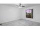 Bright bedroom with neutral walls, tile flooring, ceiling fan, and a window at 1356 Rio De Janeiro Ave # 107, Punta Gorda, FL 33983