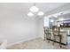 Dining area featuring stylish lighting and barstool seating adjacent to the modern kitchen at 1356 Rio De Janeiro Ave # 107, Punta Gorda, FL 33983