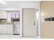 Kitchen view highlighting stainless steel appliances, granite countertops, and an access door at 1356 Rio De Janeiro Ave # 107, Punta Gorda, FL 33983