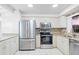 Well-equipped kitchen with stainless steel appliances, granite countertops, and tile flooring at 1356 Rio De Janeiro Ave # 107, Punta Gorda, FL 33983