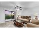 Comfortable living room featuring sliding glass doors that open to a screened-in porch with a view at 1356 Rio De Janeiro Ave # 107, Punta Gorda, FL 33983