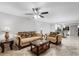 Cozy living room showcasing comfortable seating, a ceiling fan, and views into an updated kitchen at 1356 Rio De Janeiro Ave # 107, Punta Gorda, FL 33983