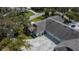 Bird's-eye view of the home with a large driveway and beautiful roof at 1474 Red Oak Ln, Port Charlotte, FL 33948