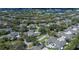 Aerial view of a home in a tree-filled neighborhood, complete with a spacious driveway at 1474 Red Oak Ln, Port Charlotte, FL 33948