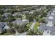 Aerial view of a neighborhood featuring single Gathering homes surrounded by mature trees at 1474 Red Oak Ln, Port Charlotte, FL 33948