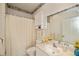 Bright bathroom with decorative wallpaper, single sink vanity, and shower with curtain at 1474 Red Oak Ln, Port Charlotte, FL 33948