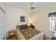 Comfortable bedroom with ceiling fan, side table, and framed artwork at 1474 Red Oak Ln, Port Charlotte, FL 33948