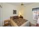 Comfortable bedroom featuring a floral comforter, ceiling fan, and side tables at 1474 Red Oak Ln, Port Charlotte, FL 33948