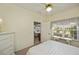Bright bedroom features a ceiling fan and a window with decorative floral valance allowing natural light at 1474 Red Oak Ln, Port Charlotte, FL 33948