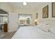 This bedroom offers a ceiling fan, light colored walls, carpet, and a sunlit window with floral valance at 1474 Red Oak Ln, Port Charlotte, FL 33948