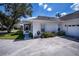 Side exterior of the home showcasing a large driveway, and enclosed porch at 1474 Red Oak Ln, Port Charlotte, FL 33948