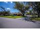 Charming home featuring a lush landscaped front yard and driveway at 1474 Red Oak Ln, Port Charlotte, FL 33948