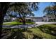 Charming home featuring a lush landscaped front yard with a welcoming two-car garage at 1474 Red Oak Ln, Port Charlotte, FL 33948