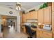 Well-lit home office with custom built-ins, tiled floors, and open doorway to the adjacent living space at 1474 Red Oak Ln, Port Charlotte, FL 33948
