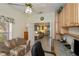 Cozy home office featuring built-in desk with upper cabinets, adjacent sitting area, and open doorway at 1474 Red Oak Ln, Port Charlotte, FL 33948