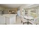 Bright kitchen with a breakfast bar that opens into the dining and living area. Breakfast nook in background at 1474 Red Oak Ln, Port Charlotte, FL 33948