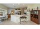 Open kitchen design with breakfast bar, white cabinets, stainless steel appliances, and adjacent dining area at 1474 Red Oak Ln, Port Charlotte, FL 33948