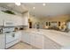 Bright kitchen featuring white countertops and cabinets and a breakfast bar overlooking the living space at 1474 Red Oak Ln, Port Charlotte, FL 33948