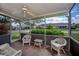 Enclosed lanai with wicker furniture providing serene view of the outdoors at 1474 Red Oak Ln, Port Charlotte, FL 33948