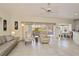 Open living space featuring neutral decor, tile floors, and adjacent dining area at 1474 Red Oak Ln, Port Charlotte, FL 33948