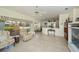 Open-concept living area with tile flooring, fan, and seamless flow to the kitchen and screened lanai at 1474 Red Oak Ln, Port Charlotte, FL 33948