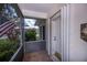 Enclosed porch with tile flooring and view of a well-maintained lawn and garden at 1474 Red Oak Ln, Port Charlotte, FL 33948