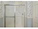 Bathroom tiled shower with glass doors and grab bars for safety at 1474 Red Oak Ln, Port Charlotte, FL 33948