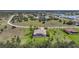 Aerial view of a home with screened pool in a residential community, showcasing the property's setting and surrounding area at 16531 San Edmundo Rd, Punta Gorda, FL 33955
