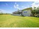Large backyard with mature trees, showcasing the property's expansive outdoor space and landscaped surroundings at 16531 San Edmundo Rd, Punta Gorda, FL 33955