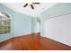Bedroom with hardwood flooring, natural light from a window, and a spacious closet at 16531 San Edmundo Rd, Punta Gorda, FL 33955