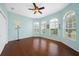 Bedroom featuring hardwood floors, multiple windows, and a ceiling fan for added comfort at 16531 San Edmundo Rd, Punta Gorda, FL 33955