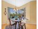 Cozy breakfast nook overlooking a screened-in pool area, providing natural light and a scenic view at 16531 San Edmundo Rd, Punta Gorda, FL 33955