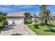 Charming single-story home showcasing a lush lawn, mature trees, and a spacious three-car garage at 16531 San Edmundo Rd, Punta Gorda, FL 33955