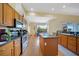 Open kitchen featuring stainless steel appliances, a central island, and hardwood floors at 16531 San Edmundo Rd, Punta Gorda, FL 33955
