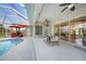 Screened lanai features a swimming pool, dining area, and outdoor kitchen at 16531 San Edmundo Rd, Punta Gorda, FL 33955