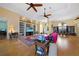 Spacious open-plan living room featuring hardwood floors, built-in shelving, and access to the outdoor living space at 16531 San Edmundo Rd, Punta Gorda, FL 33955