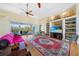 Inviting living room with wood floors, built-in shelving, and sliding glass doors to the outdoor pool at 16531 San Edmundo Rd, Punta Gorda, FL 33955